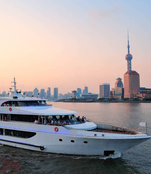 Boat in Huangpu River with Shanghai urban architecture